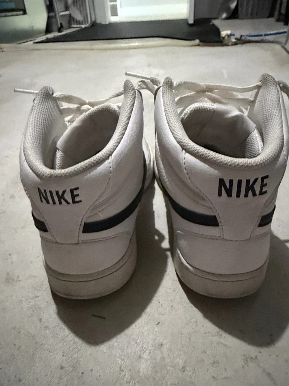Nike White High-Top Sneakers with Black Swoosh